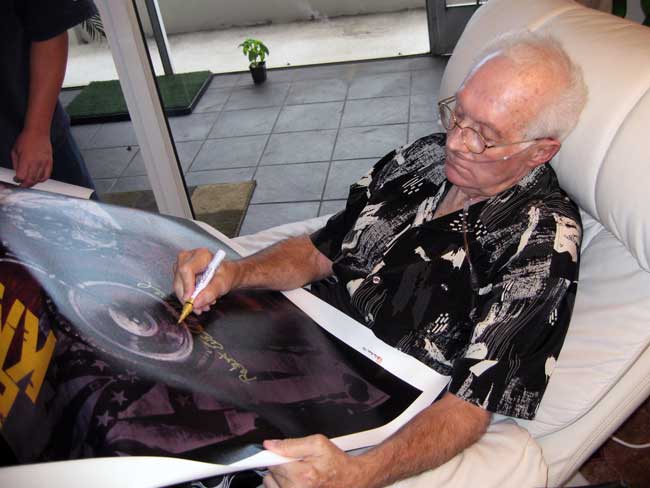 Evel Knievel signing his Stephen Holland prints